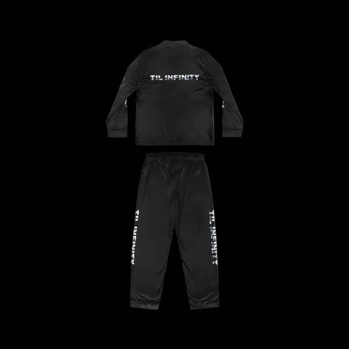 TIL INFINITY “Snooze You Lose” sleepwear set in black satin, with a long-sleeve top and drawstring pants featuring white lettering.