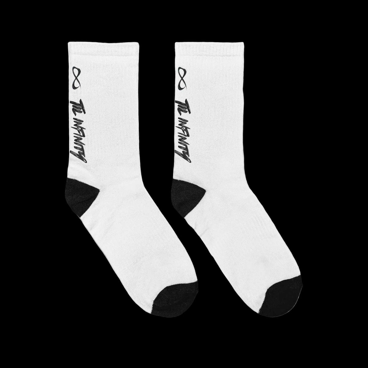 Unisex Padded Crew Socks in white ribbed knit with black heel and toe, vertical black TIL INFINITY lettering and infinity symbol.